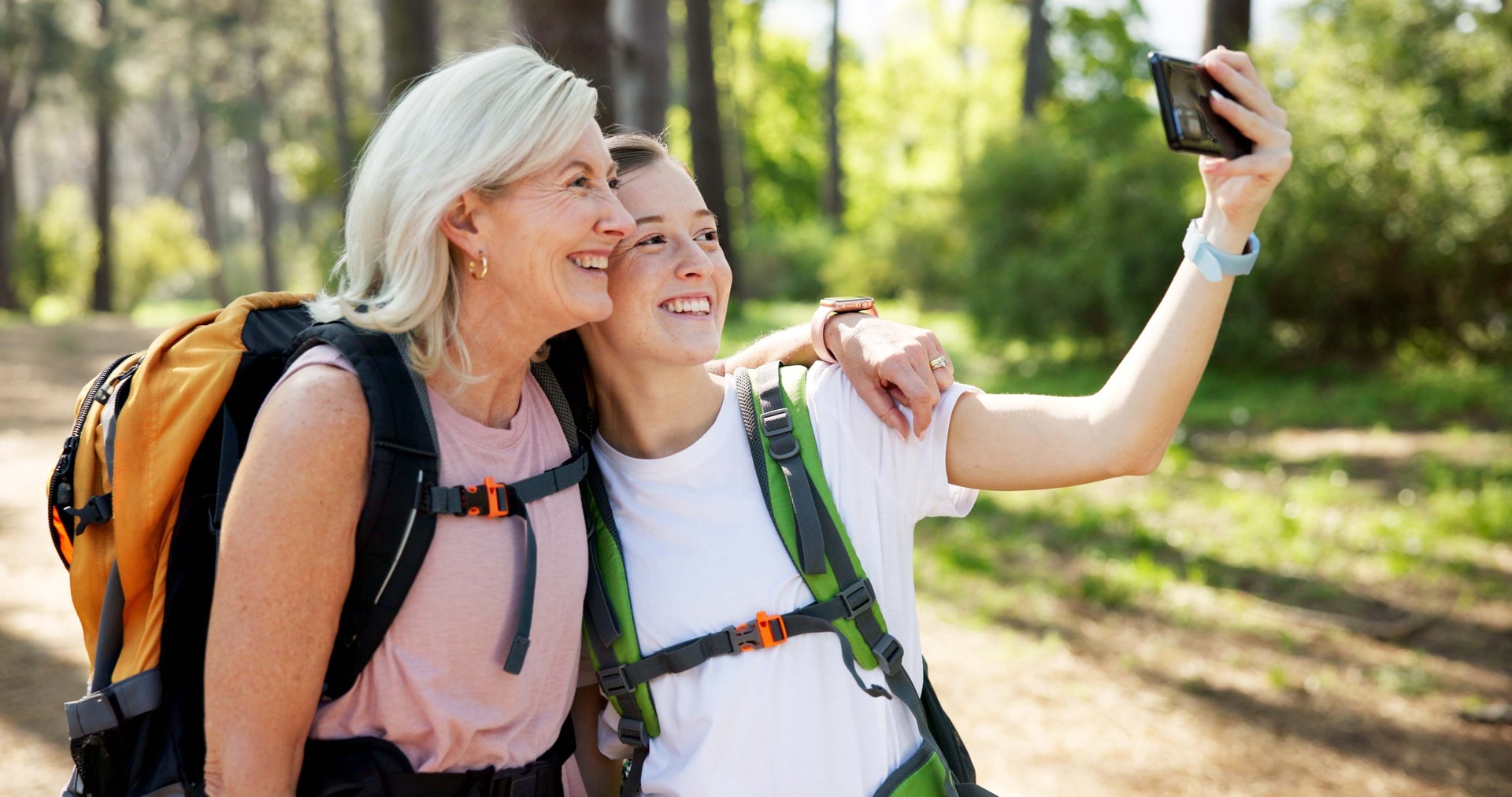 Nature, hiking and women with hug for selfie, document memory and bonding for profile picture. Outdoor, senior mother and daughter with photography for social media, fitness experience and wellness