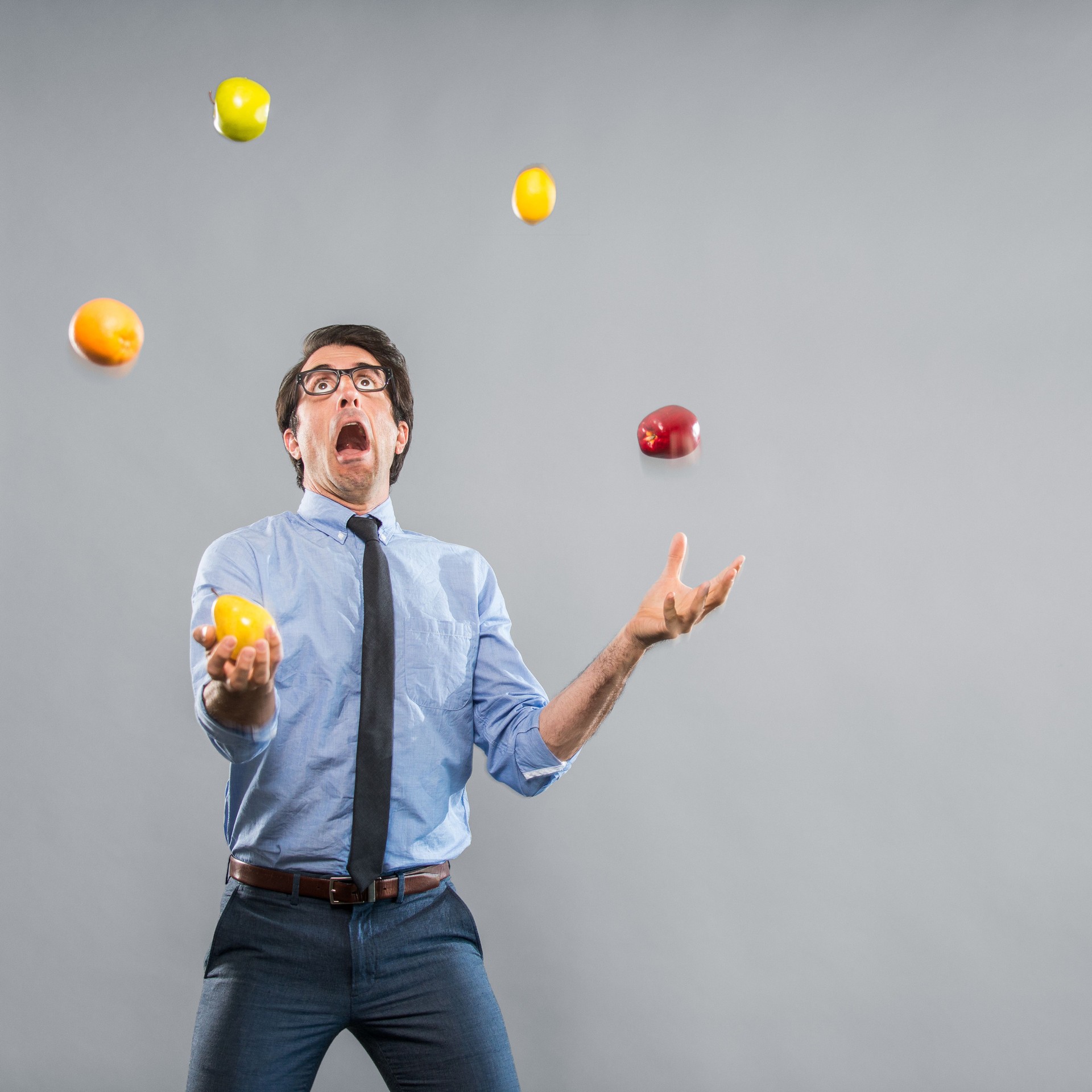 Out of Control Nerdy Businessman Juggeling Fruits